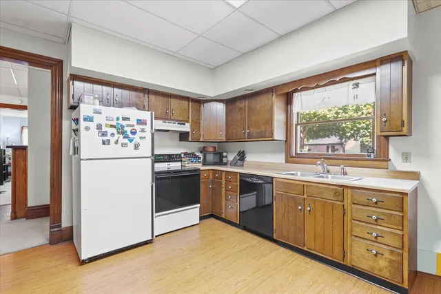 a kitchen with a stove a sink and a refrigerator