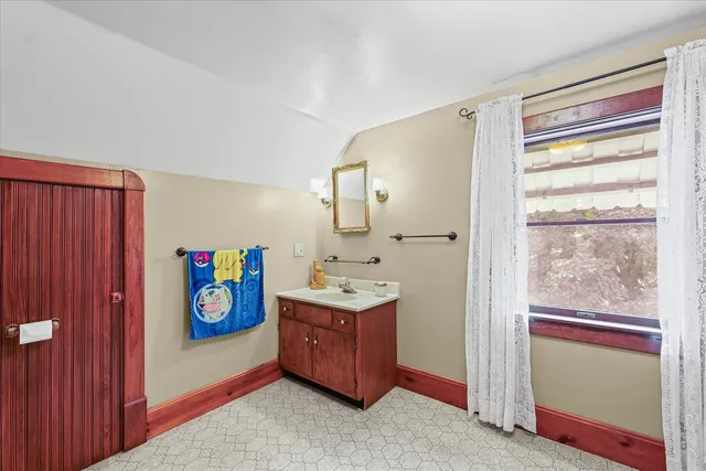 a view of bedroom with walk in closet and window