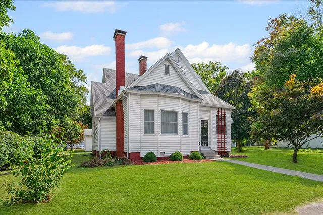 a front view of a house with garden