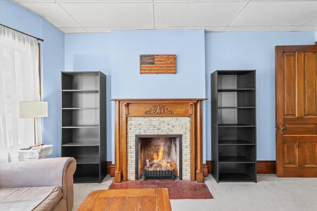 a living room with a fireplace cabinet and a fireplace