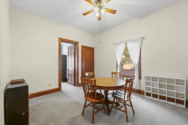 a dining room with furniture and window