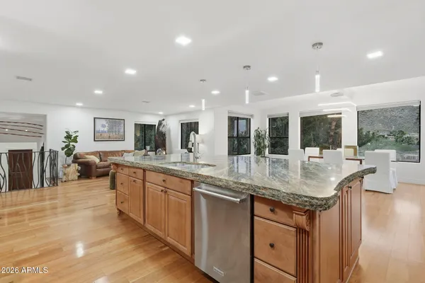 a kitchen with granite countertop lots of counter top space and living room