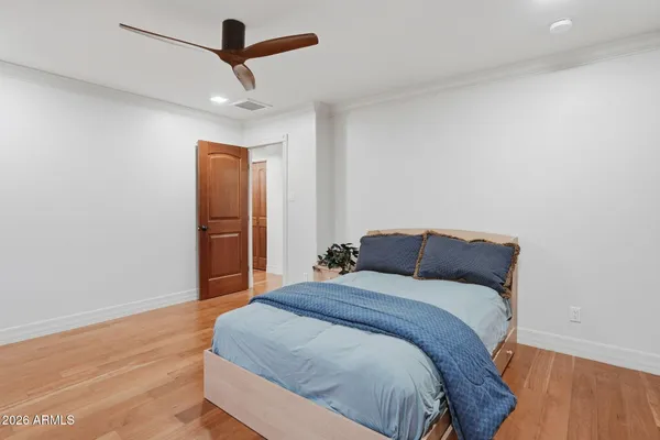 a bedroom with a large bed and a window