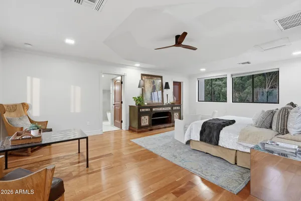 a bedroom with a bed and a large window