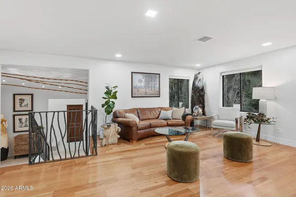 a living room with furniture a lamp and a potted plant