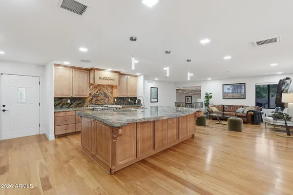 a kitchen with stainless steel appliances granite countertop a lot of counter top space and cabinets