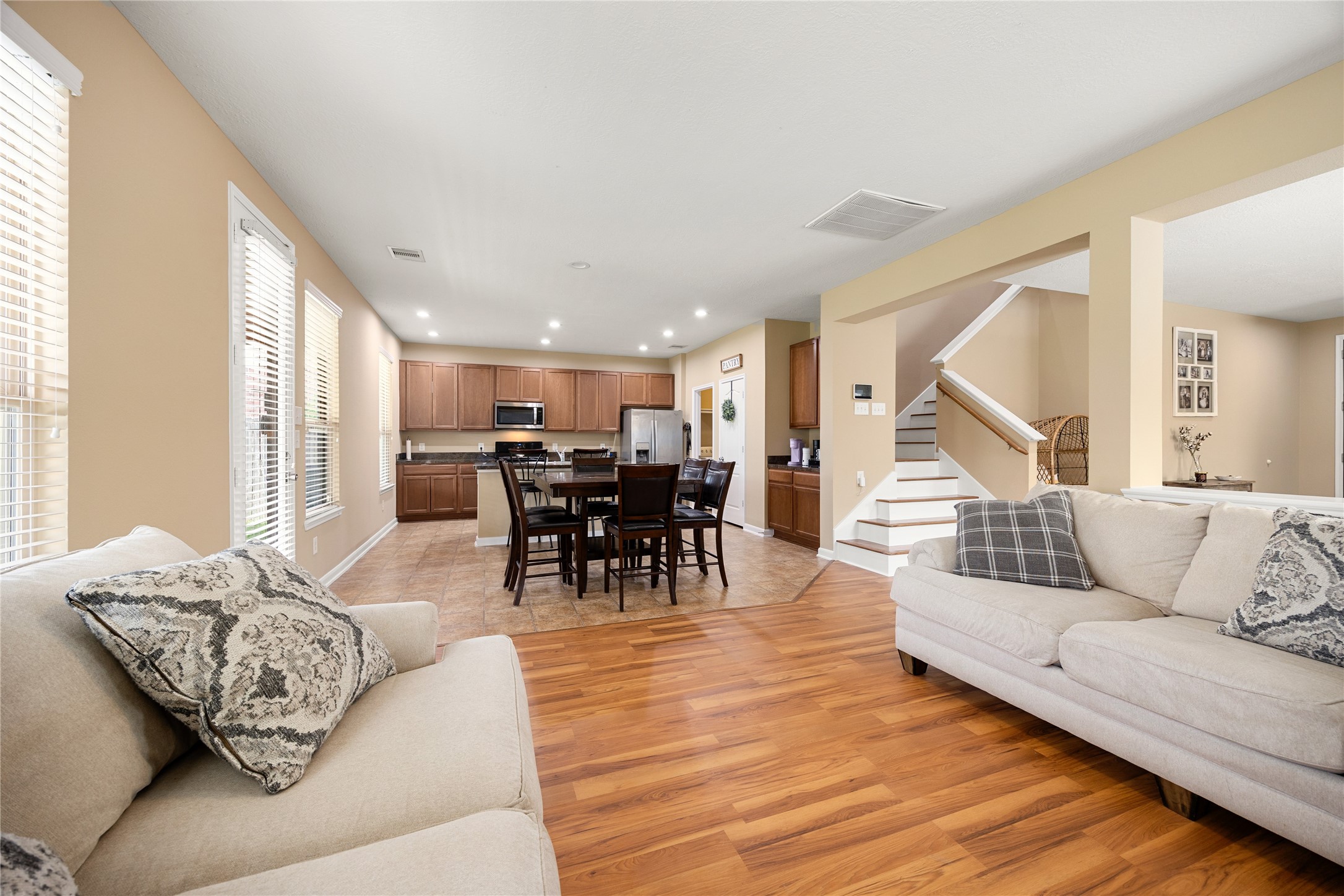 22414 Bellwick Ridge Lane Katy, TX 77449 - Photo 4 of 16 Spacious open-concept living area features cozy seating and flows seamlessly into a modern kitchen with ample cabinetry and stainless steel appliances.