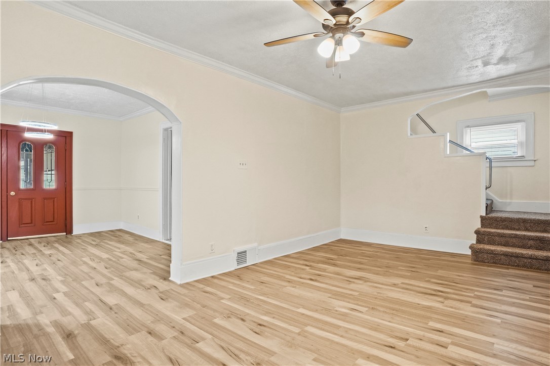 688 Ranney Street Akron, OH 44310 - Photo 14 of 35 Spare room featuring ceiling fan, light hardwood / wood-style floors, and ornamental molding