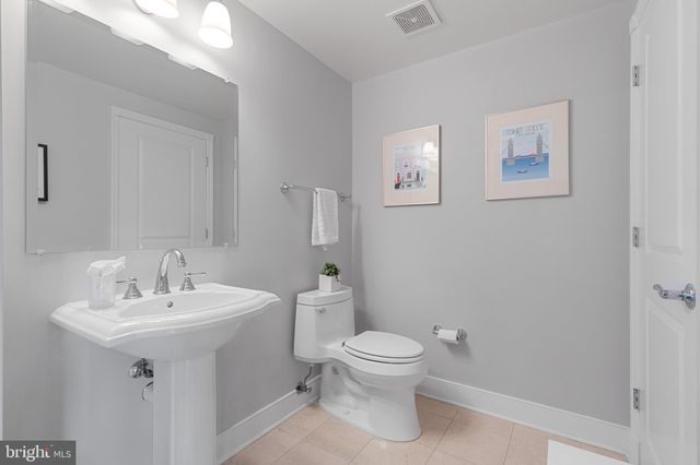 a white toilet sitting next to a bathroom sink