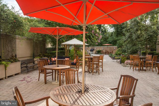 a view of a patio with a dining table and chairs under an umbrella