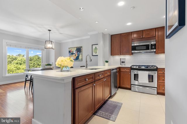 a kitchen with a sink stove and microwave