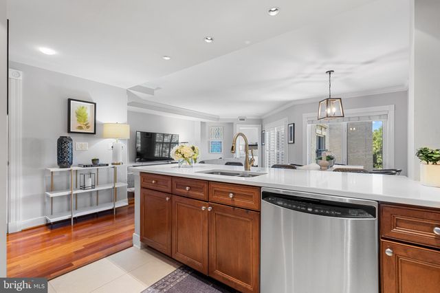 a kitchen with sink stove and refrigerator
