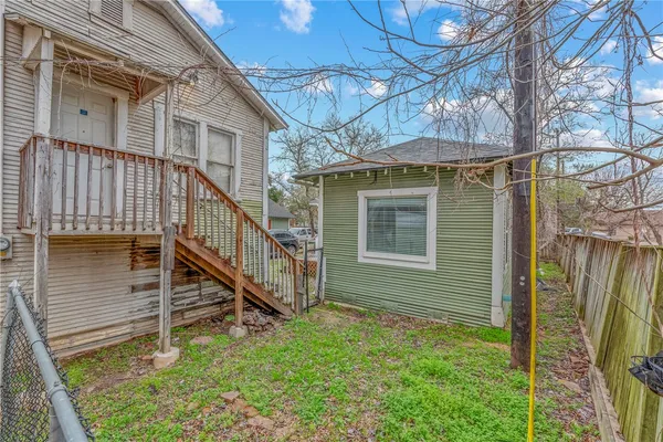 a view of a house with a small yard and wooden floor and a yard
