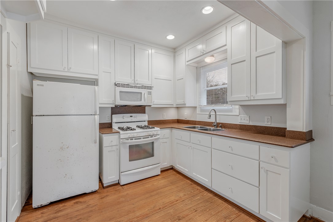 304 North Haswell Drive Bryan, TX 77803 - Photo 7 of 17 a kitchen with stainless steel appliances granite countertop a refrigerator sink and cabinets