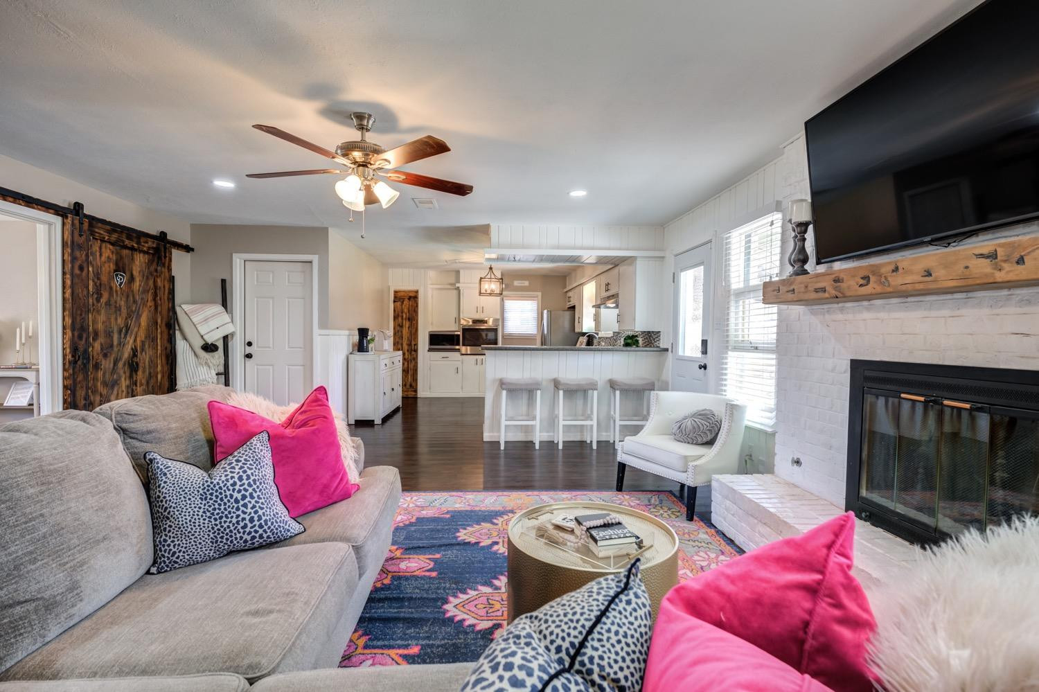 2306 61st Street Lubbock, TX 79412 - Photo 11 of 35 a living room with furniture and a fireplace