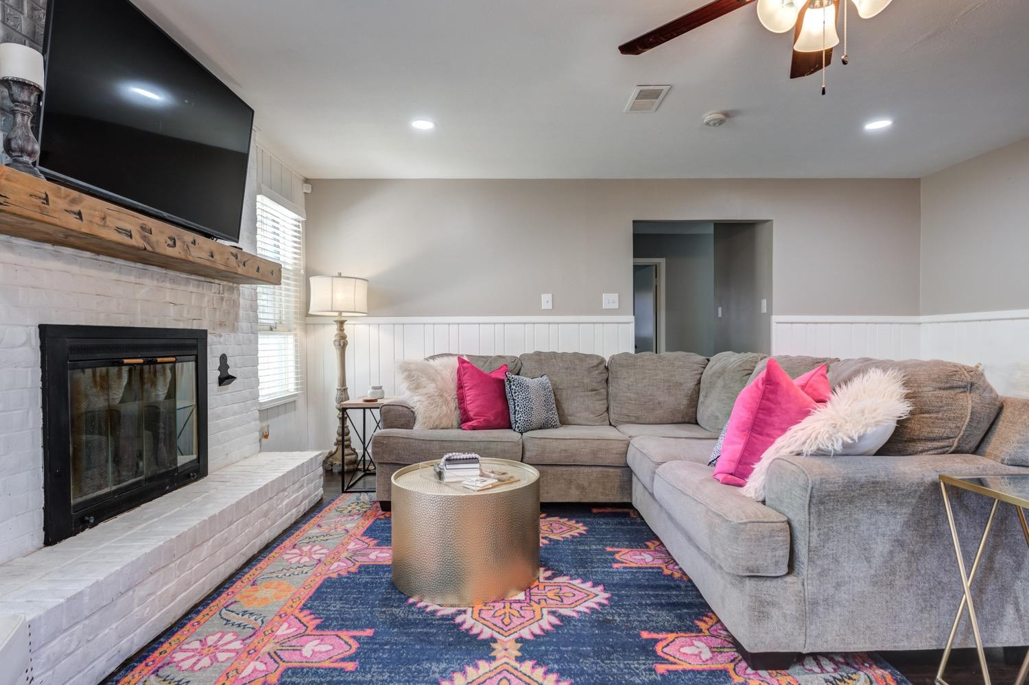 2306 61st Street Lubbock, TX 79412 - Photo 13 of 35 a living room with furniture and a fireplace