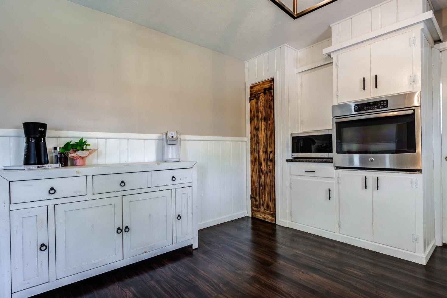 2306 61st Street Lubbock, TX 79412 - Photo 14 of 35 a kitchen with stainless steel appliances white cabinets and wooden floors