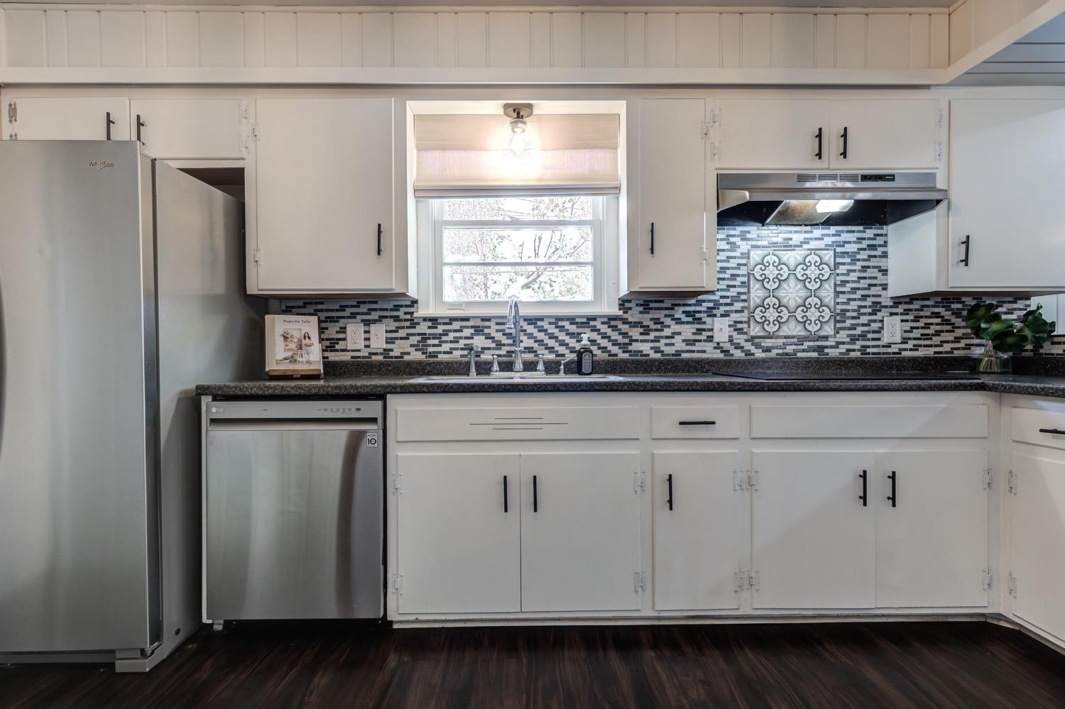 2306 61st Street Lubbock, TX 79412 - Photo 16 of 35 a kitchen with stainless steel appliances white cabinets and a sink