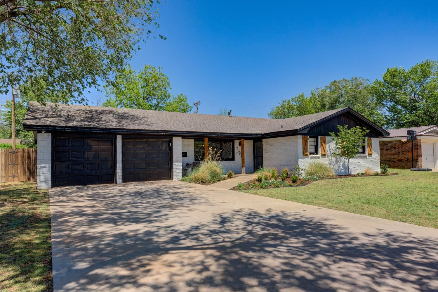 2306 61st Street Lubbock, TX 79412 - Photo 2 of 35 a front view of a house with a yard and potted plants