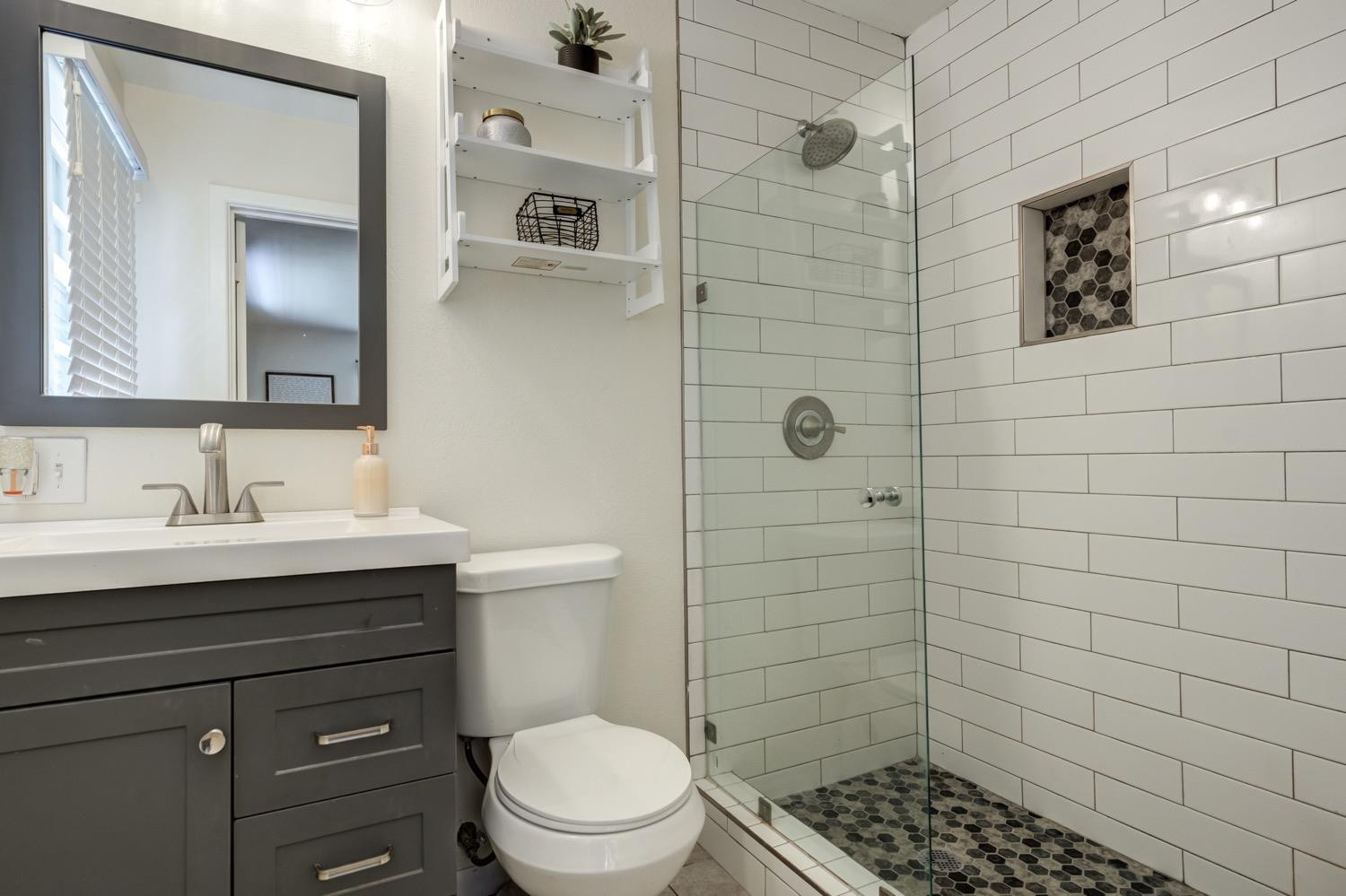 2306 61st Street Lubbock, TX 79412 - Photo 24 of 35 a bathroom with a sink a toilet and shower