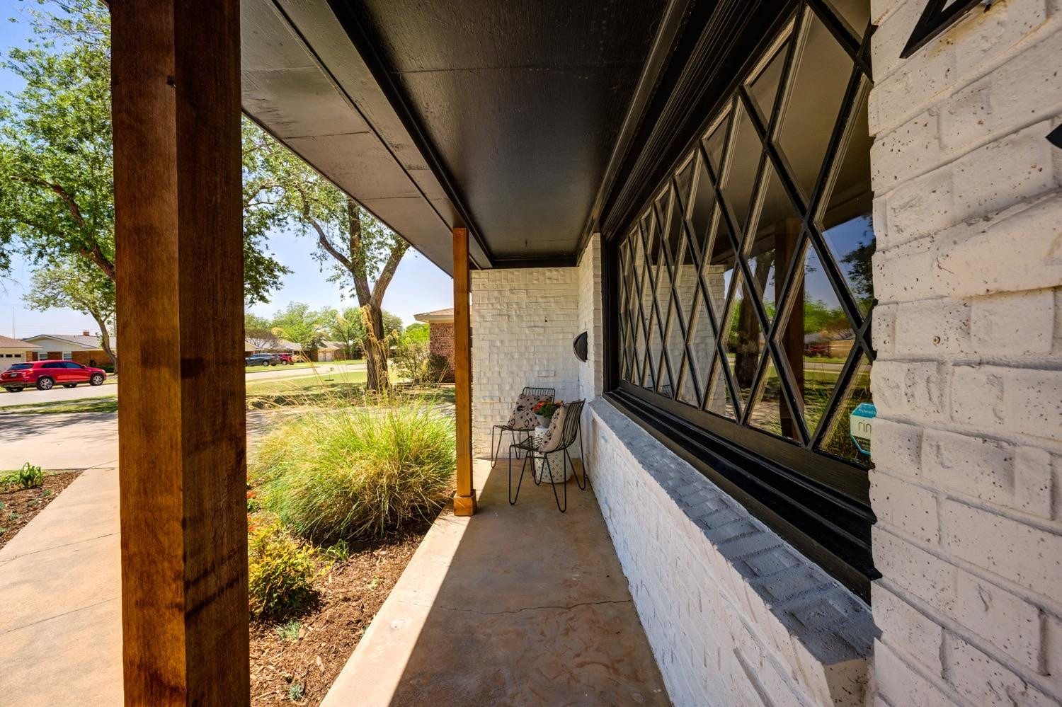 2306 61st Street Lubbock, TX 79412 - Photo 4 of 35 a view of a balcony with wooden floor and stairs