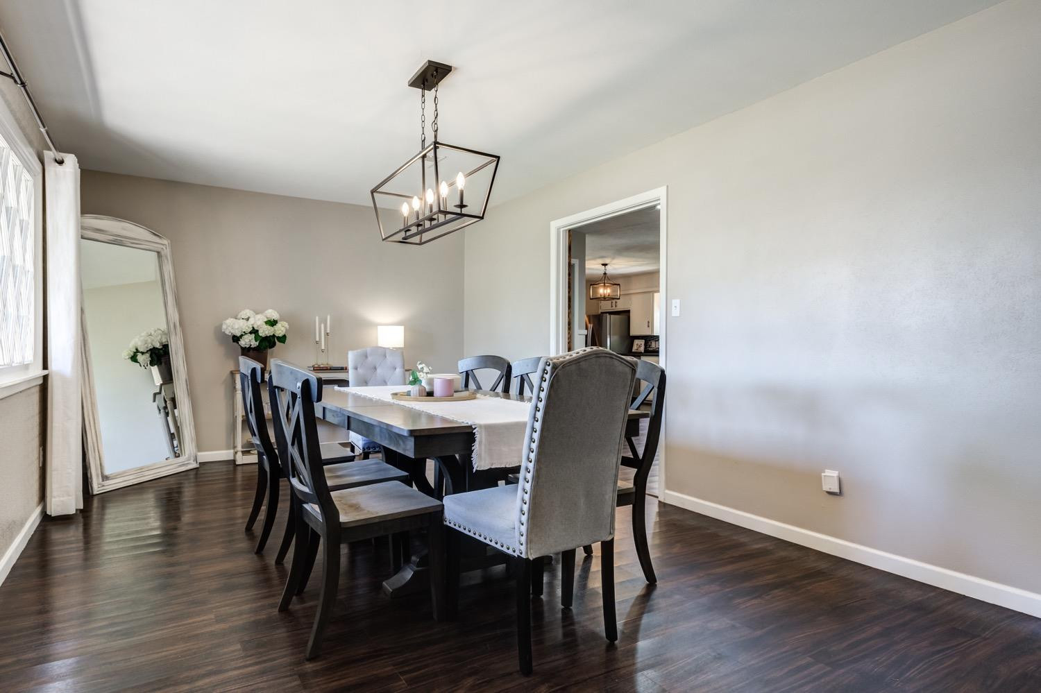 2306 61st Street Lubbock, TX 79412 - Photo 6 of 35 a view of a dining room with furniture wooden floor and chandelier