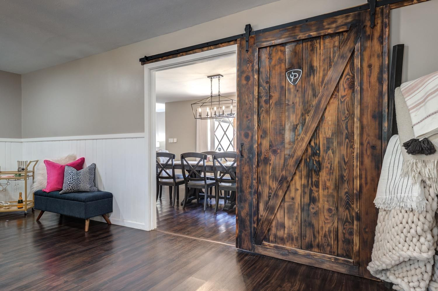 2306 61st Street Lubbock, TX 79412 - Photo 9 of 35 a view of a livingroom with furniture wooden floor and front door