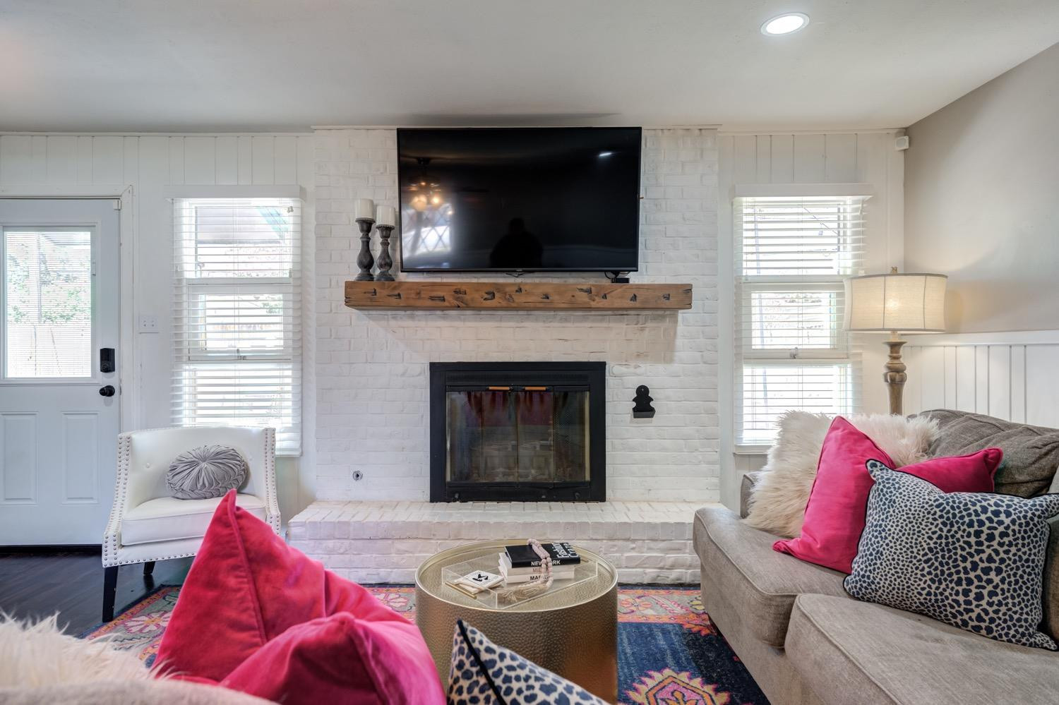 2306 61st Street Lubbock, TX 79412 - Photo 10 of 35 a living room with furniture flat screen tv and a fireplace