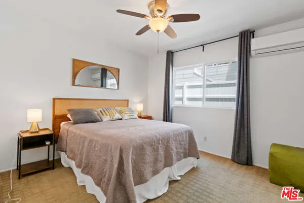 a bedroom with a bed and a window