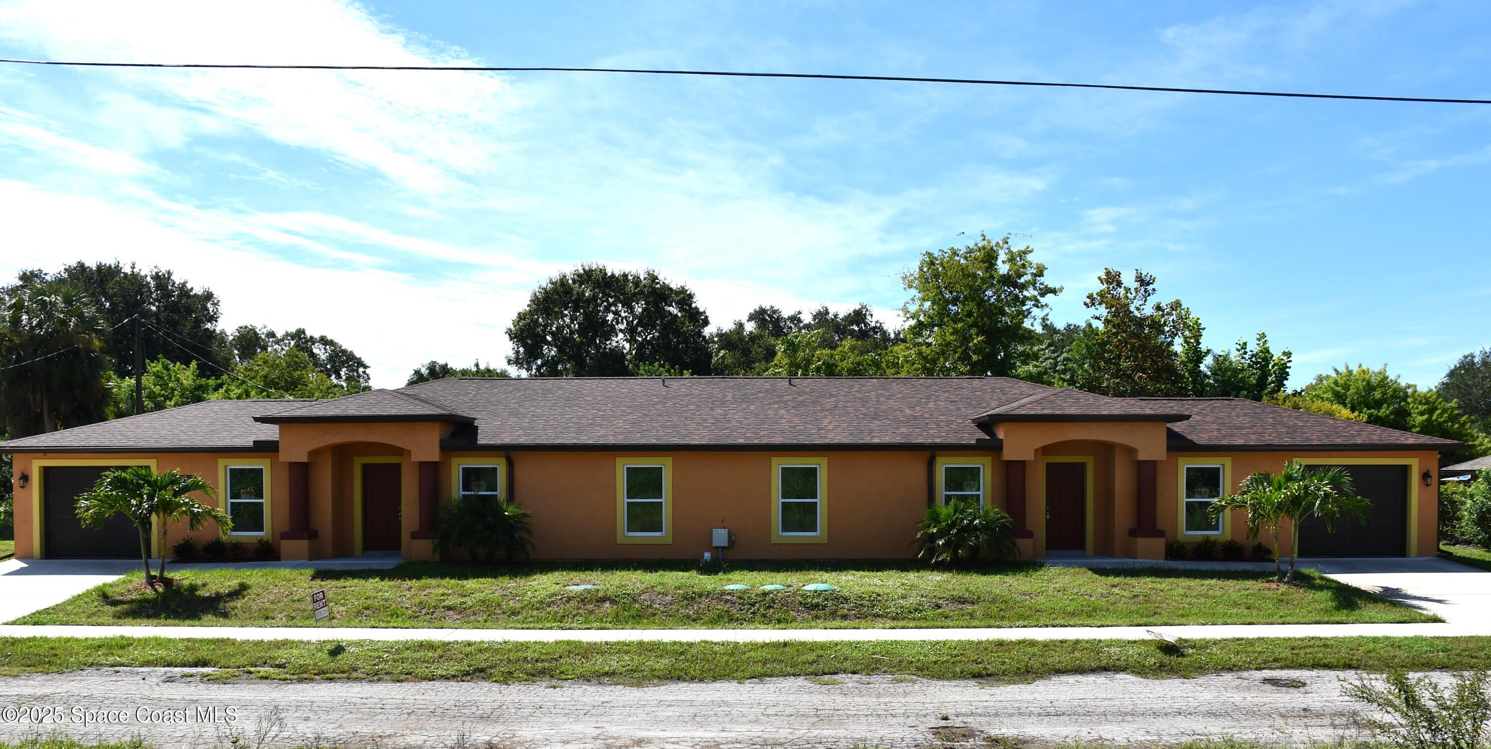 1515 Furnari Street Cocoa, FL 32922 - Photo 1 of 14 a front view of a house with a yard