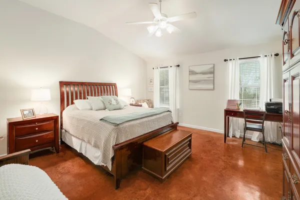 a bedroom with a bed and a table