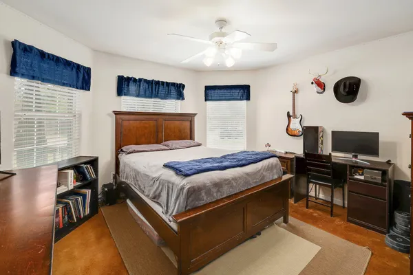 a bedroom with a bed and a television