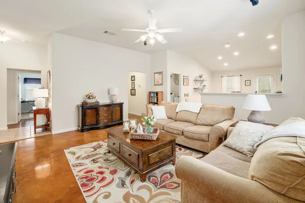 a living room with furniture and a wooden floor