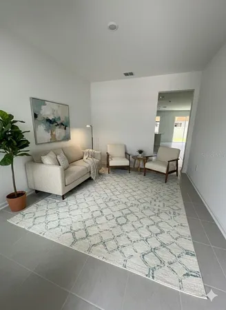 a living room with furniture and a potted plant