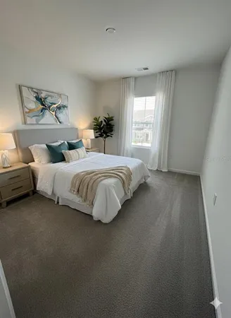 a bedroom with bed and window