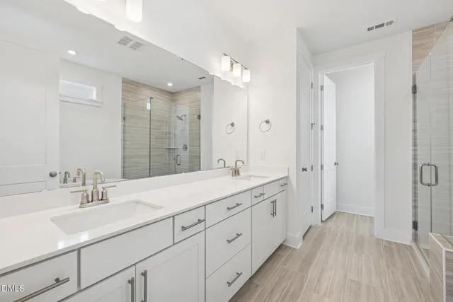 an empty room with wooden floor and ceiling fan