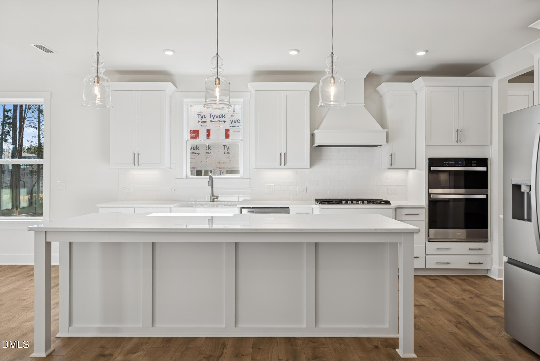 1213 Opal Lane Durham, NC 27705 - Photo 14 of 50 a kitchen with kitchen island granite countertop a sink a counter space appliances and cabinets
