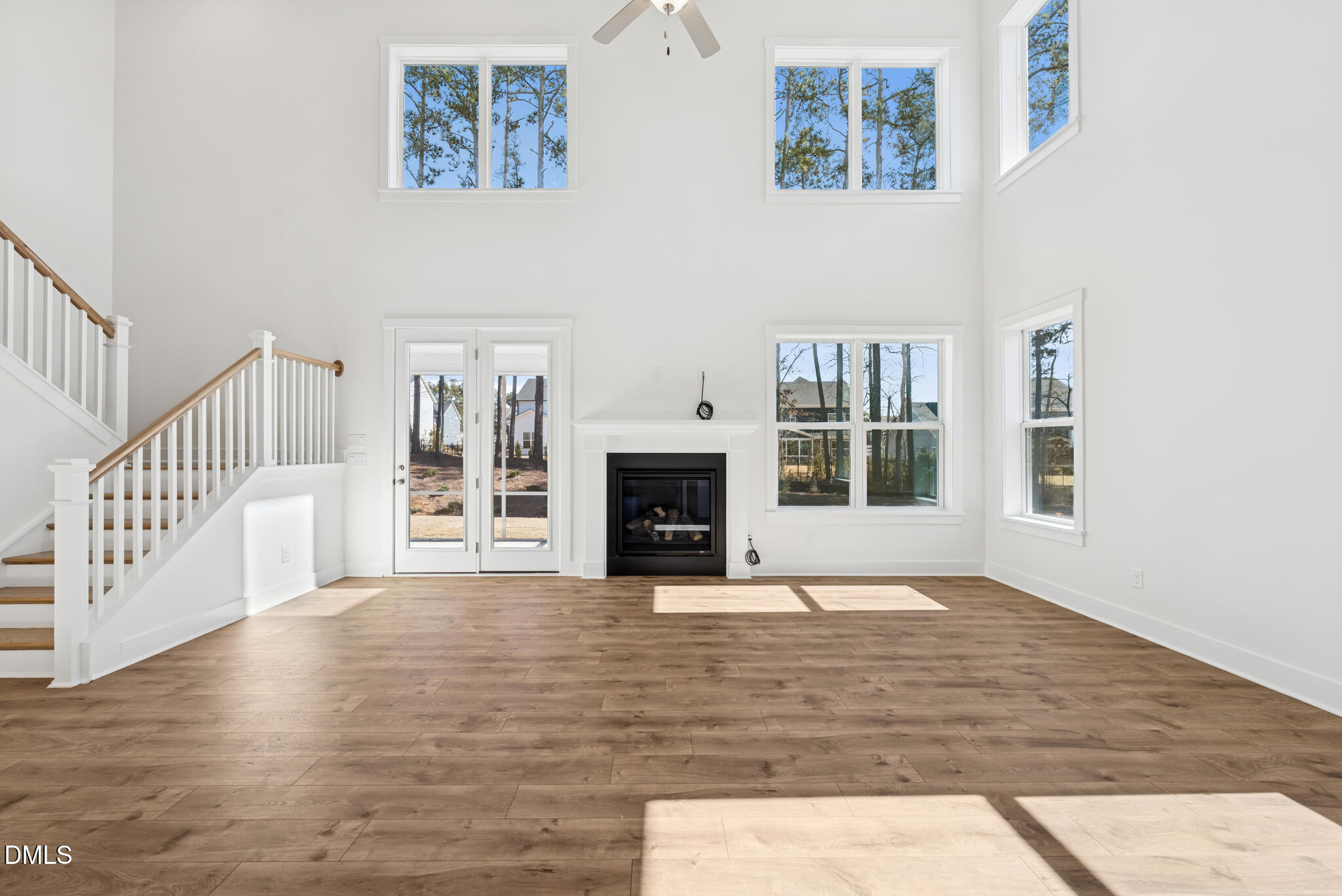1213 Opal Lane Durham, NC 27705 - Photo 16 of 50 a view of an empty room with wooden floor and a fireplace