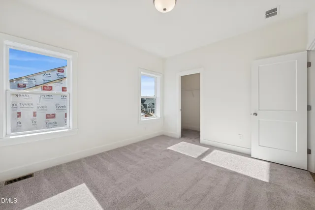 a view of an empty room and wooden floor