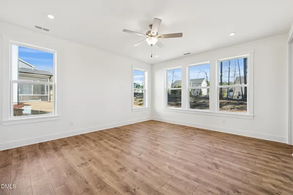 a view of an empty room and wooden floor