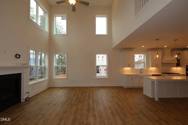 a view of a room with wooden floor and fireplace