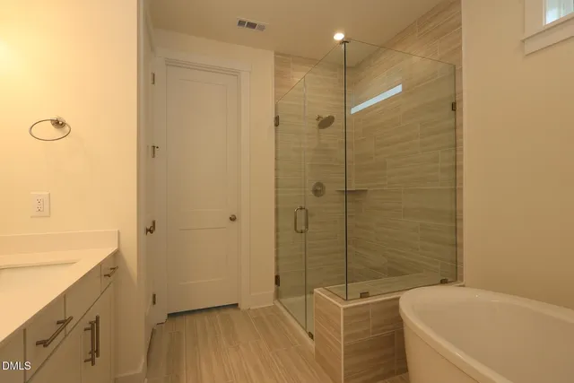 a bathroom with a bathtub and a shower