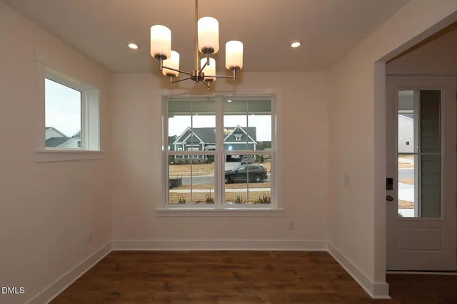 a room with wooden floor and windows