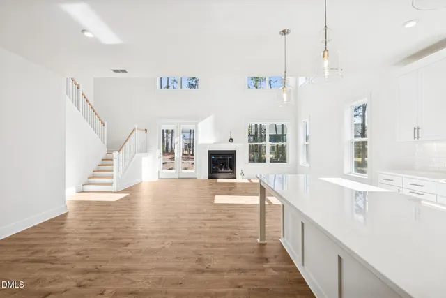 a view of a kitchen with wooden floor and a sink