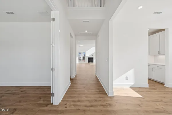 a view of a hallway with wooden floor