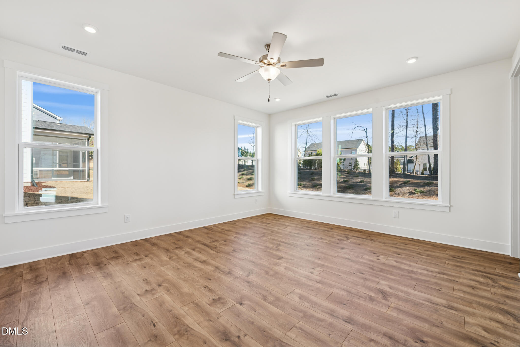 1213 Opal Lane Durham, NC 27705 - Photo 5 of 50 a view of an empty room with a window and wooden floor