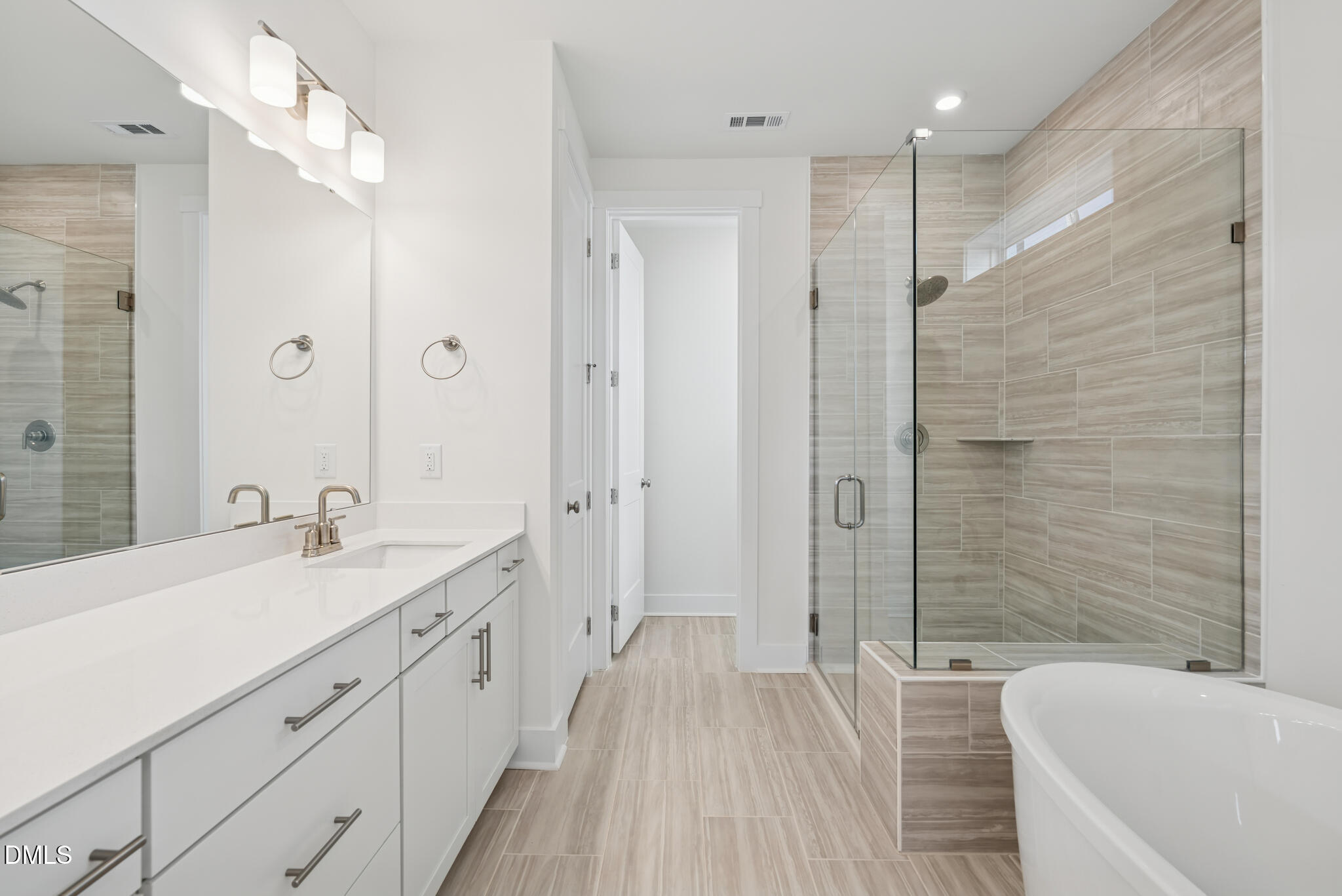 1213 Opal Lane Durham, NC 27705 - Photo 8 of 50 a spacious bathroom with a shower sink and a mirror