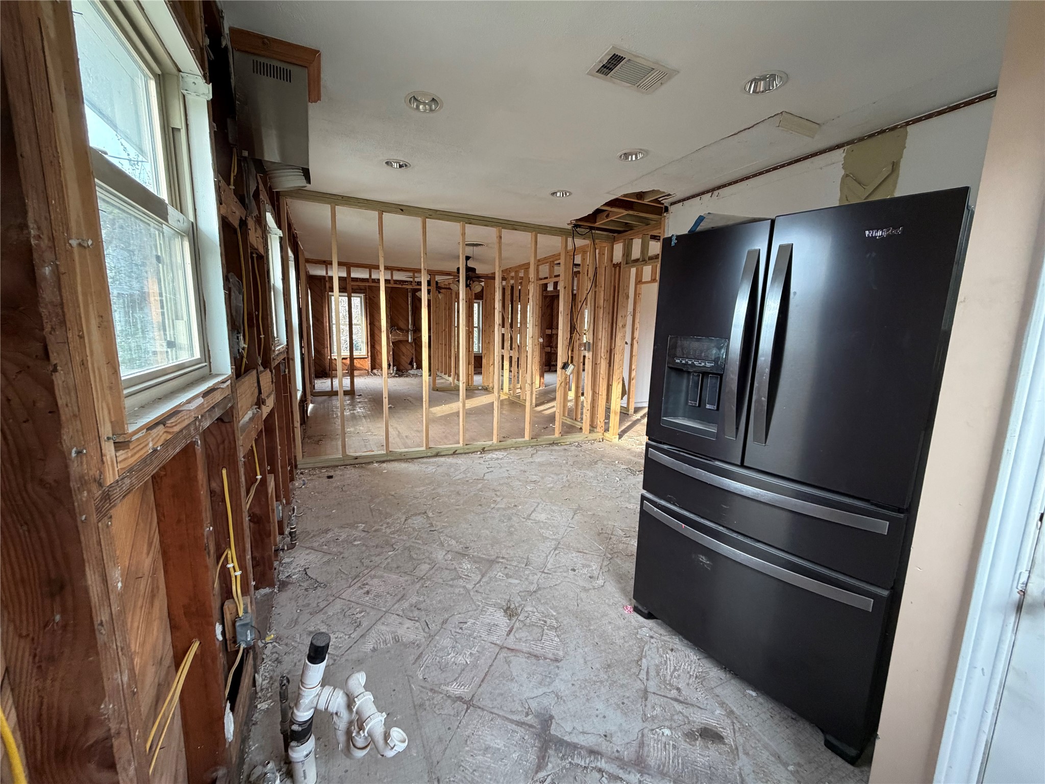 611 Mathis Street Houston, TX 77009 - Photo 11 of 22 a view of an empty room with wooden floor and stairs