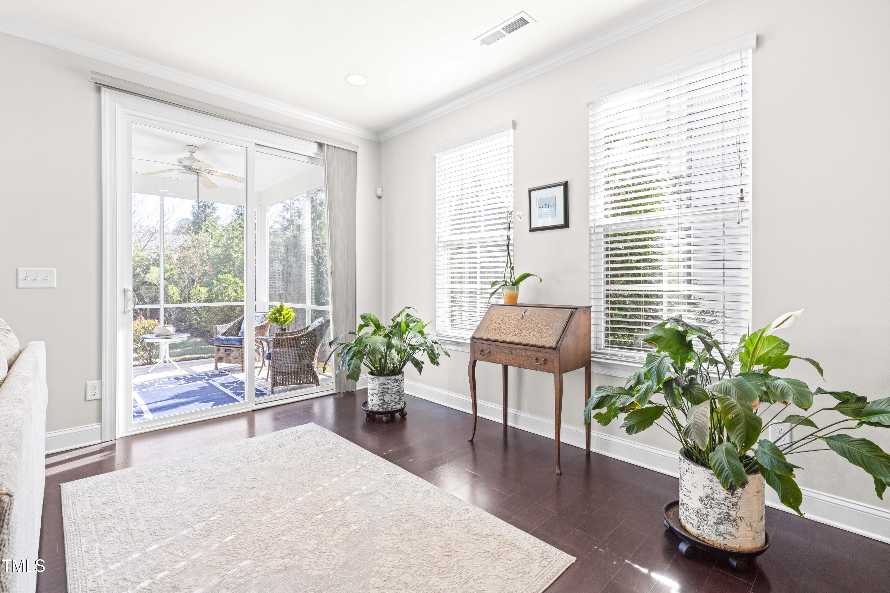 1805 Bodwin Lane Apex, NC 27502 - Photo 11 of 43 a living room with furniture potted plant and a window