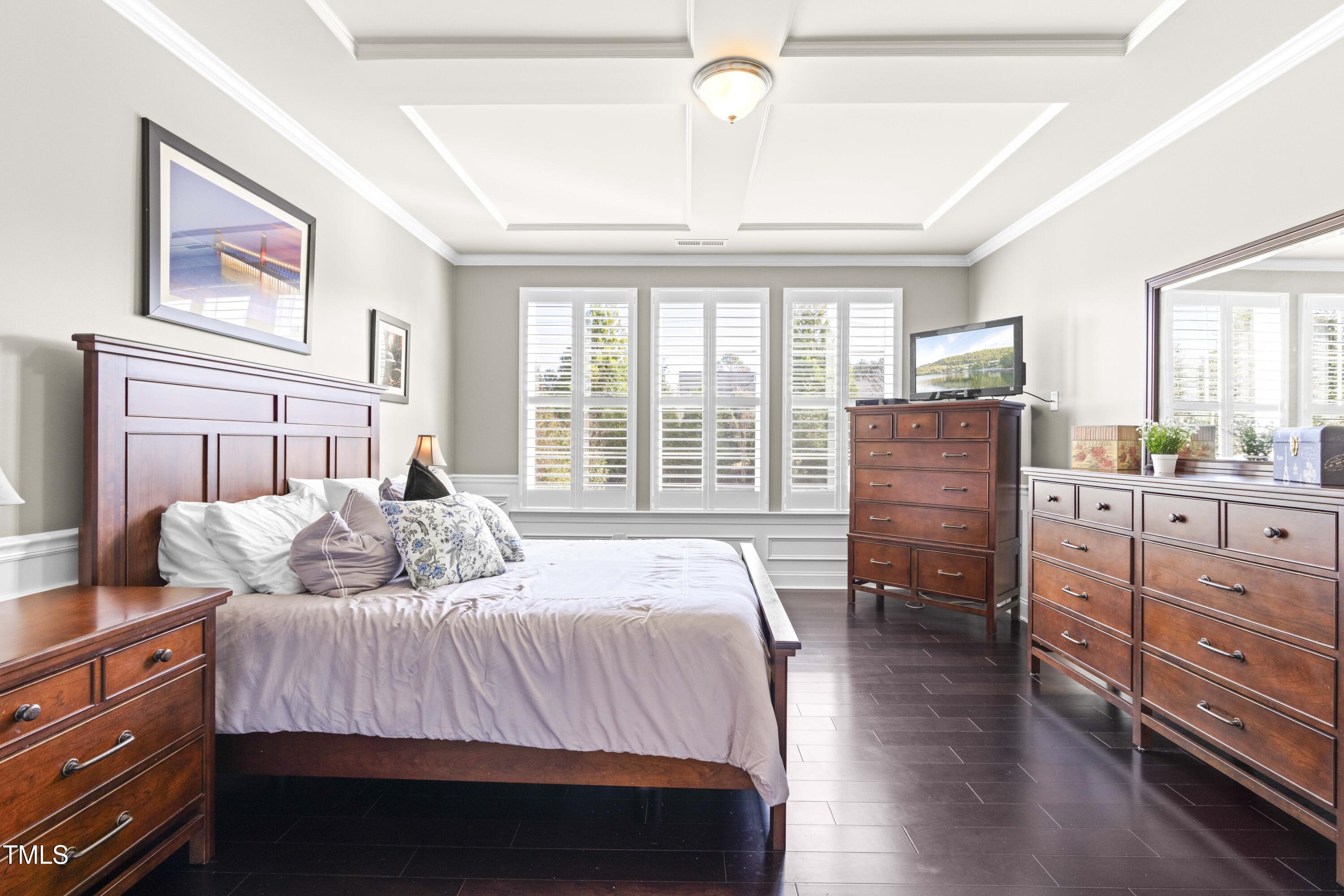 1805 Bodwin Lane Apex, NC 27502 - Photo 17 of 43 a bedroom with a bed and wooden floor